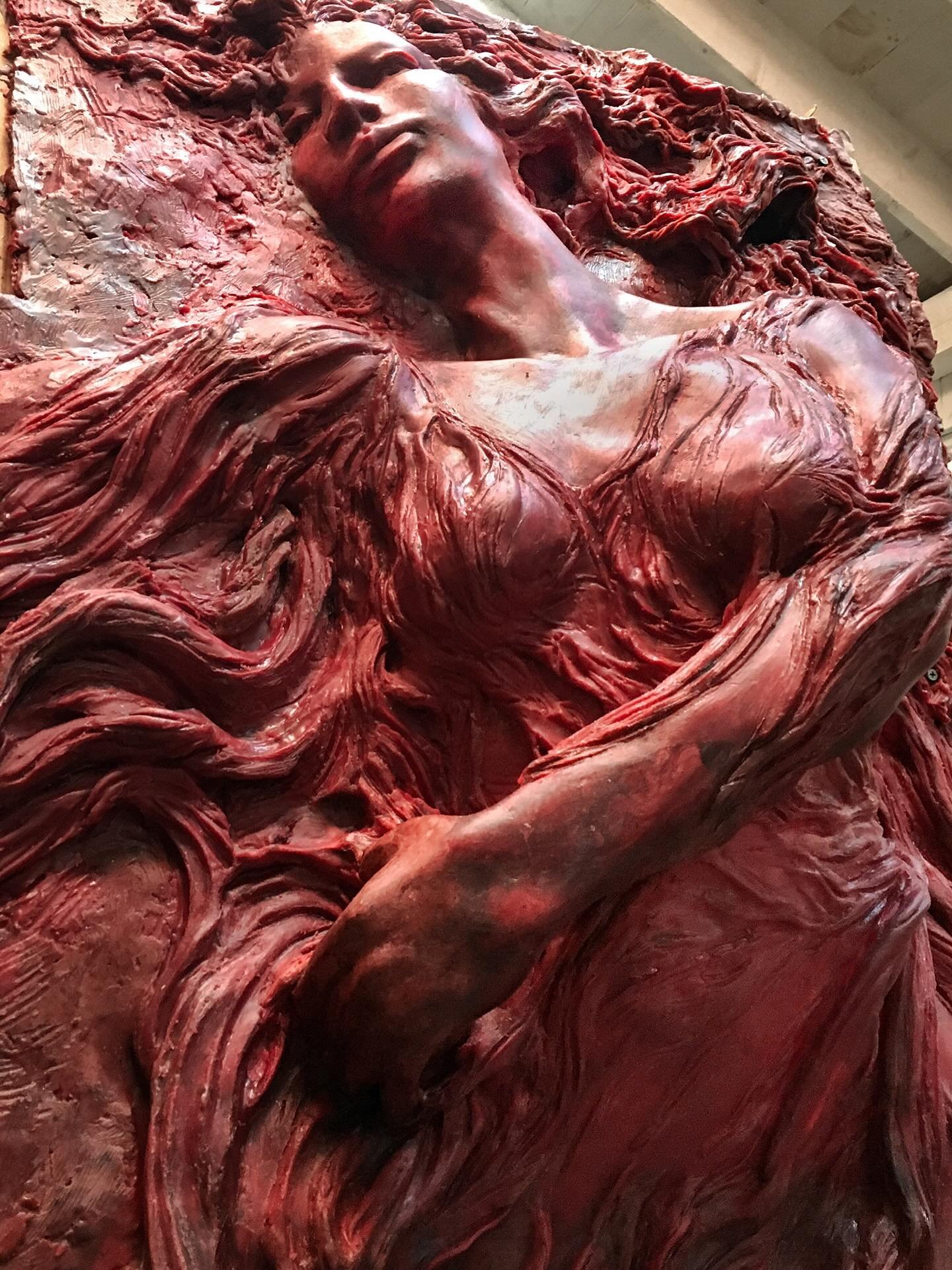 Red wax is how the path to bronze casting starts, the red color allows us to see the wax clearly and reduce reflections, giving true insight into what is to come when the sculpture becomes lustorus metal.

Calliope  in progress in the studio for edit